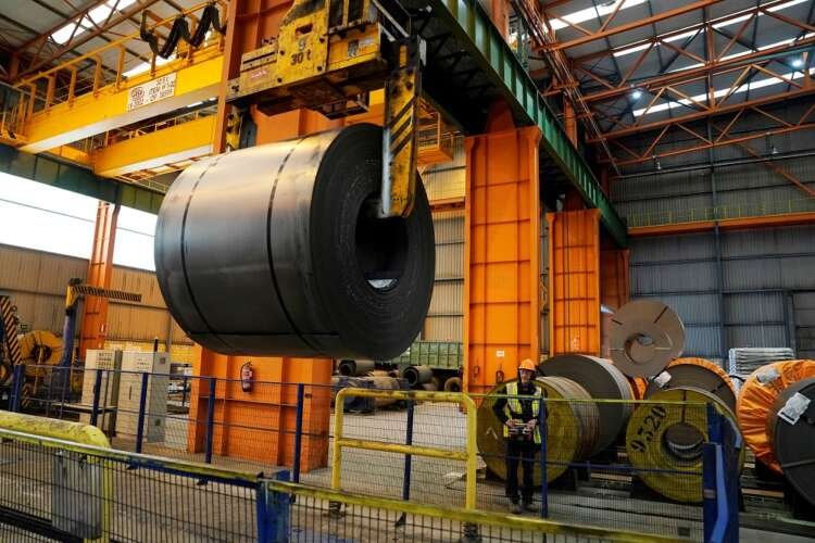 FILE PHOTO: A steel roll is moved by the crane at the ArcelorMittal steel plant in Sestao