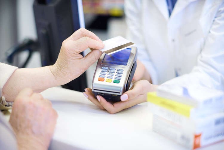 Close-up of contactless payment at pharmacy, highlighting digital transactions - Global Banking & Finance Review