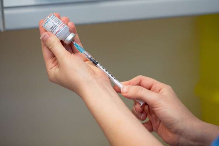 Healthcare worker administering the Moderna COVID-19 Omicron vaccine - Global Banking & Finance Review