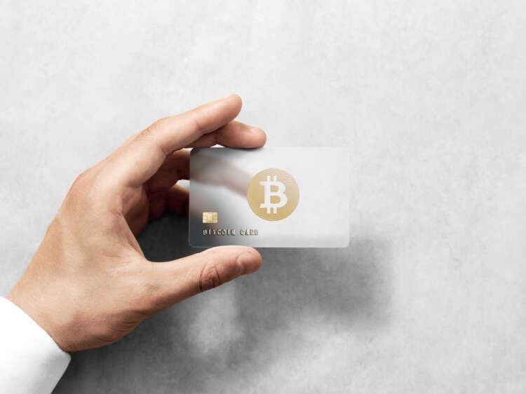Hand holding a bitcoin card, symbolizing seamless crypto payment solutions - Global Banking & Finance Review