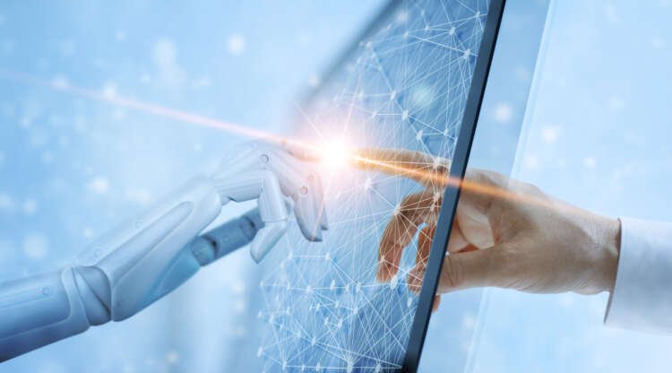 Hands of a robot and a human connecting, symbolizing collaboration in finance - Global Banking & Finance Review