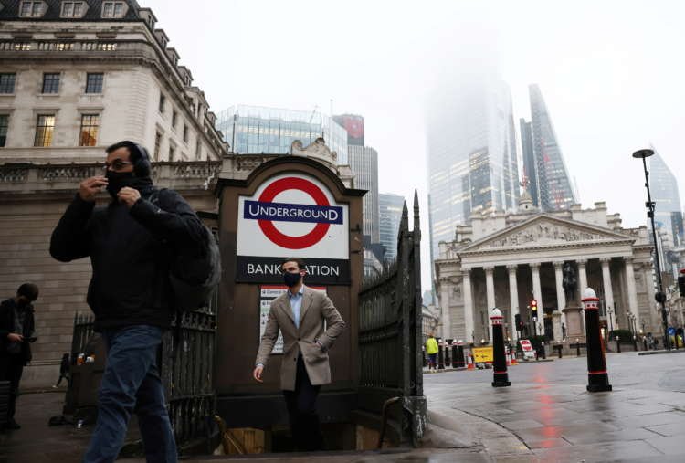 People exit Bank station in London's financial district during COVID-19 - Global Banking & Finance Review