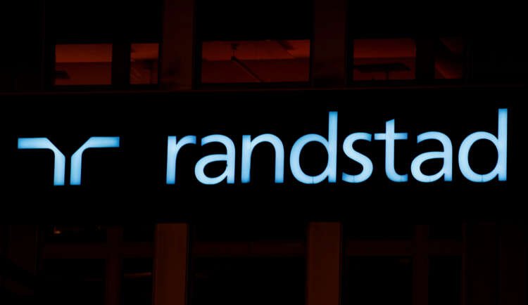 Randstad logo displayed prominently in an office setting - Global Banking & Finance Review