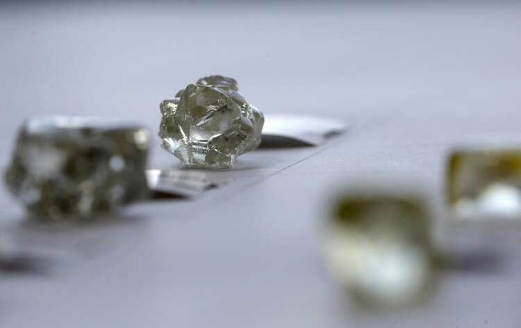 Close-up of diamonds displayed, symbolizing De Beers' return to Angola - Global Banking & Finance Review