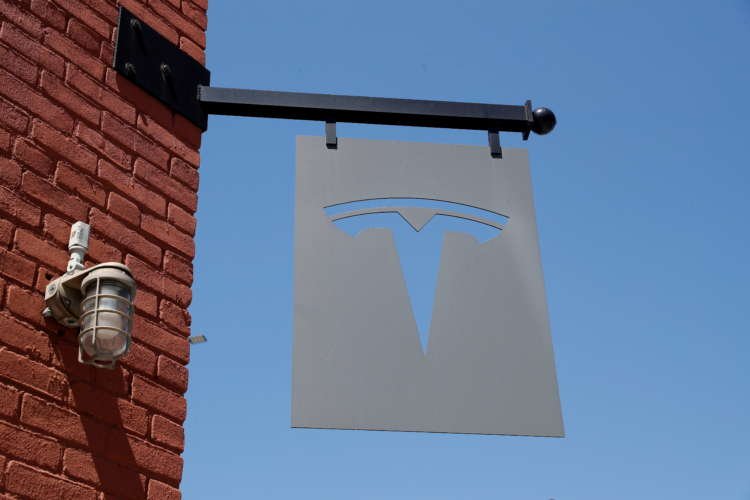 Tesla logo outside dealership highlighting Q1 results drop - Global Banking & Finance Review