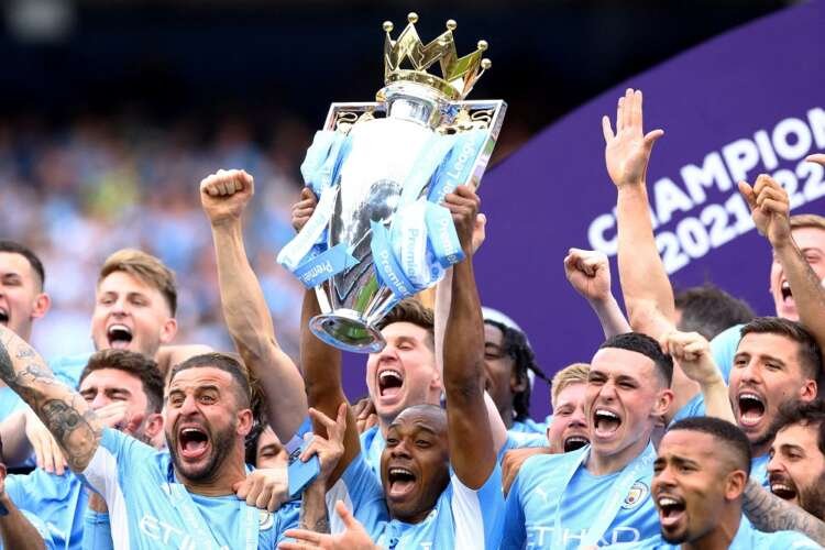 Manchester City players celebrating during a match - Premier League title defence 2022 - Global Banking & Finance Review