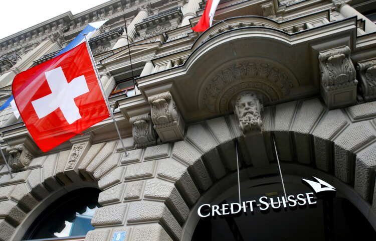 Flag of Switzerland with Credit Suisse logo, reflecting banking strategies - Global Banking & Finance Review