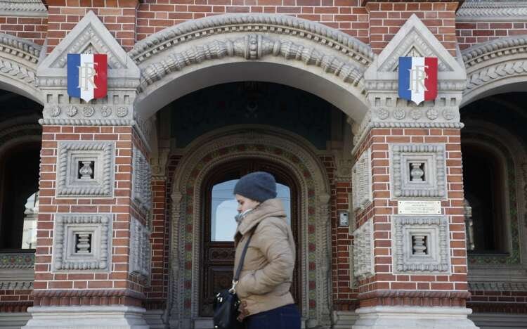 A woman walks past the French embassy in Moscow amid Russia's expulsion of diplomats - Global Banking & Finance Review