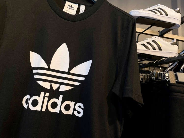 Image of Adidas logo with Yeezy sneakers, highlighting the impact of Kanye West split - Global Banking & Finance Review