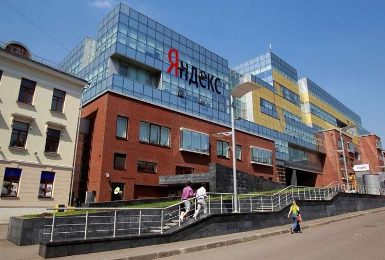 FILE PHOTO: People walk near the headquarters of Yandex company in Moscow