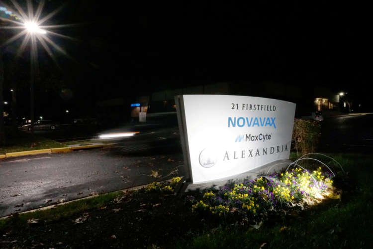 FILE PHOTO: A car drives past the sign for vaccine developer Novavax at the company’s headquarters in Gaithersburg