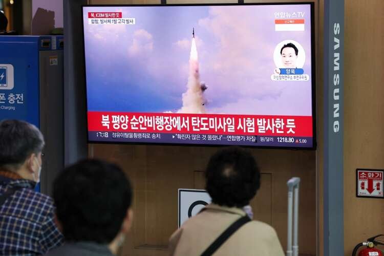People watch a TV broadcasting a news report on North Korea’s intercontinental ballistic missile (ICBM) test, in Seoul