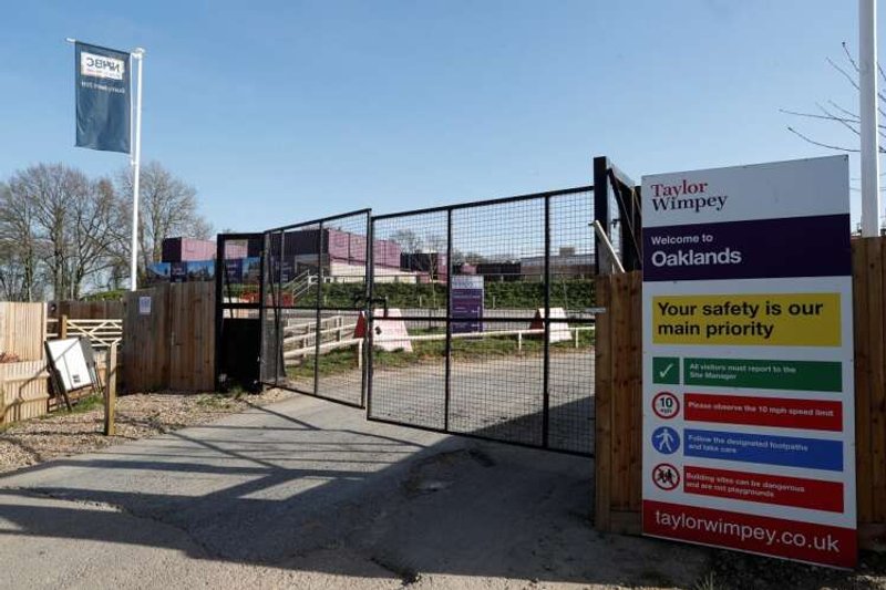 Image for Taylor Wimpey looks at job cuts to rein in costs, lowers homebuilding target