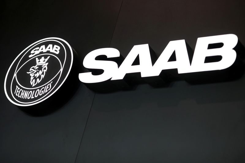 Saab's logo and military equipment, illustrating organic sales growth in defense sector - Global Banking & Finance Review