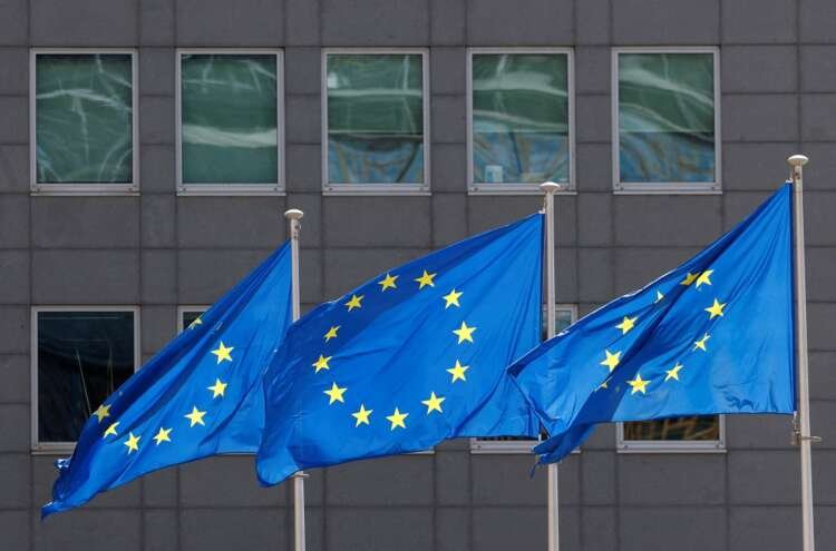 European Union flags at the EU Commission headquarters, symbolizing Greece's exit from enhanced surveillance - Global Banking & Finance Review