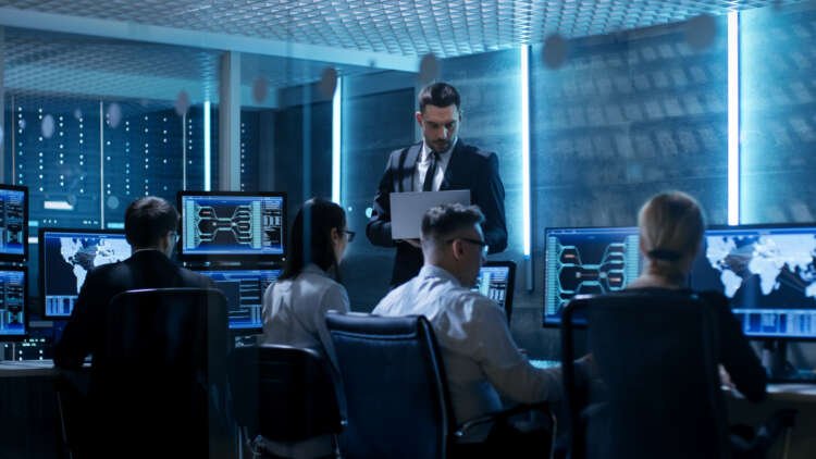 IT professionals collaborating in a tech control center, enhancing digital transformation - Global Banking & Finance Review