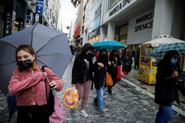 People in Athens wearing masks amid rising inflation and economic challenges - Global Banking & Finance Review