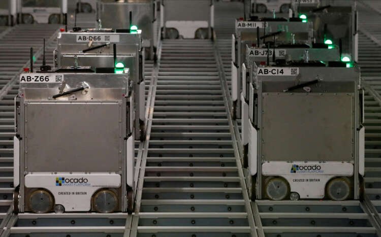 Ocado robots in a warehouse, illustrating the patent dispute with AutoStore - Global Banking & Finance Review