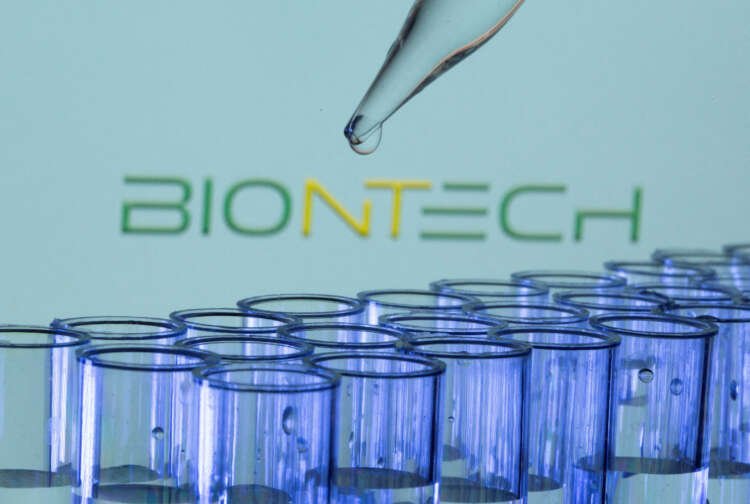 Test tubes with BioNTech logo symbolizing AI advancement in biopharma - Global Banking & Finance Review