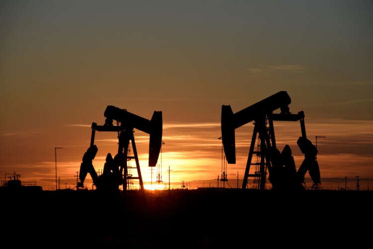Oil pumps work at sunset, symbolizing rising oil prices amid supply cuts - Global Banking & Finance Review