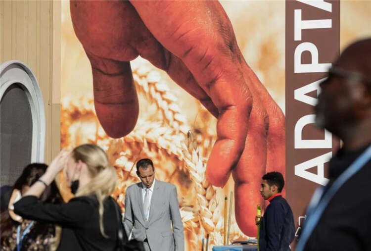 People enter the COP27 climate summit in Sharm el-Sheikh, addressing climate loss and damage funding - Global Banking & Finance Review