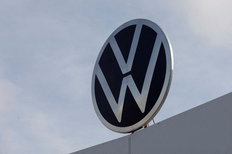 Volkswagen logo and car showcasing target profit margin of 6.5% - Global Banking & Finance Review