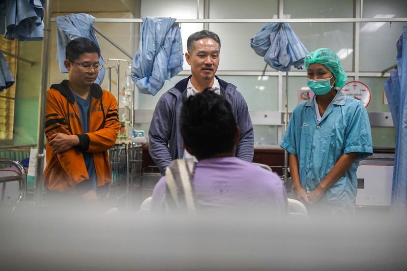 Doctors assisting an elderly Myanmar refugee in a hospital - US Aid Freeze Impact on Healthcare - Global Banking & Finance Review