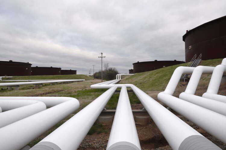 FILE PHOTO: Pipelines run to Enbridge Inc.’s crude oil storage tanks at their tank farm in Cushing