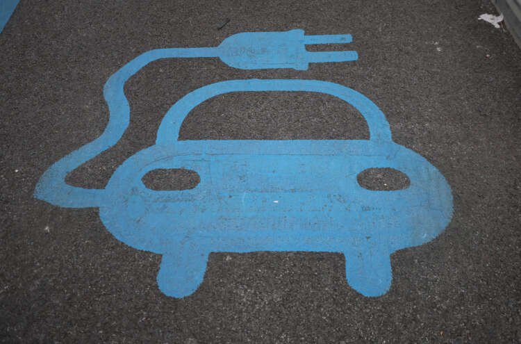 Electric car charging station inside ALDI car park, illustrating e-car subsidy demand - Global Banking & Finance Review