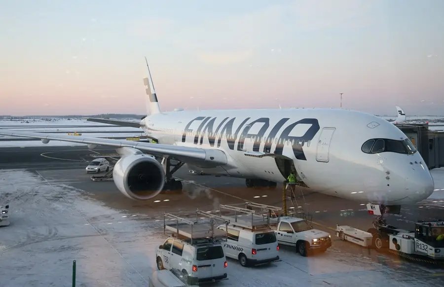Finnair logo with declining stock chart, reflecting tightened profit outlook - Global Banking & Finance Review