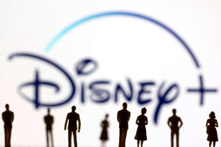 Toy figures representing people in front of Disney+ logo, symbolizing the Disney-Charter dispute - Global Banking & Finance Review