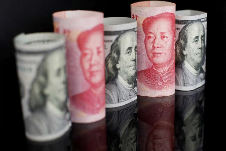 Banknotes of Chinese yuan and U.S. dollar illustrating currency fluctuations amid COVID unrest - Global Banking & Finance Review