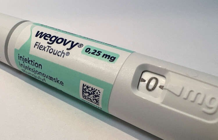 Injection pen of Novo Nordisk's Wegovy weight-loss drug displayed on a table - Global Banking & Finance Review