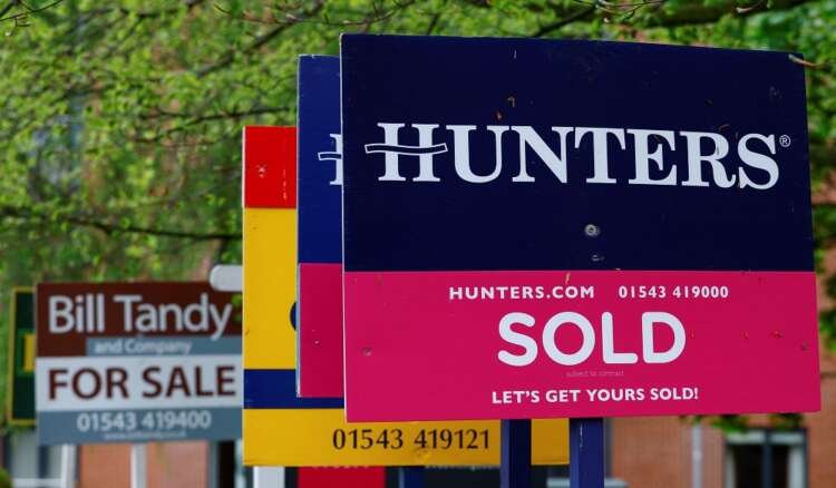 Real estate signs indicating property sales amidst UK's cost of living crisis - Global Banking & Finance Review