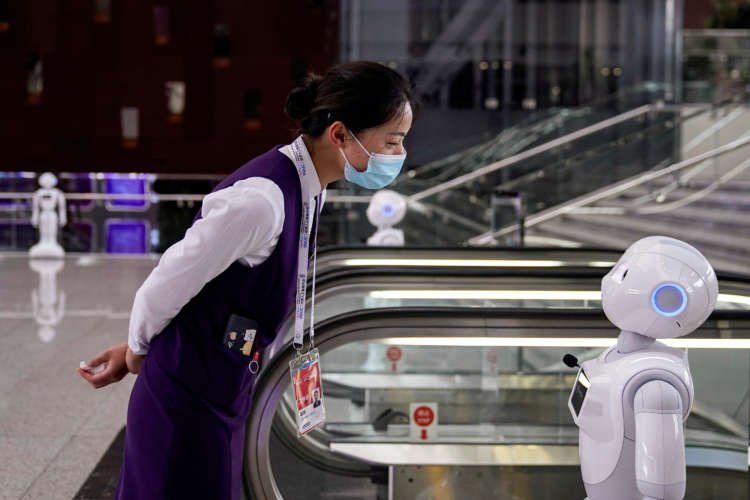 A staff member at the WAIC venue in Shanghai discussing ethical AI initiatives - Global Banking & Finance Review