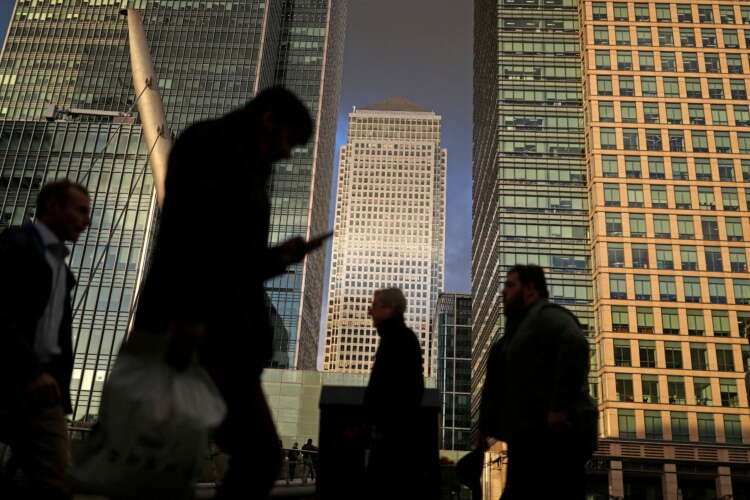 Busy professionals walk through Canary Wharf, symbolizing hiring demand in finance - Global Banking & Finance Review