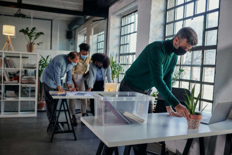 Business professional adjusting office space for a safe return to work - Global Banking & Finance Review