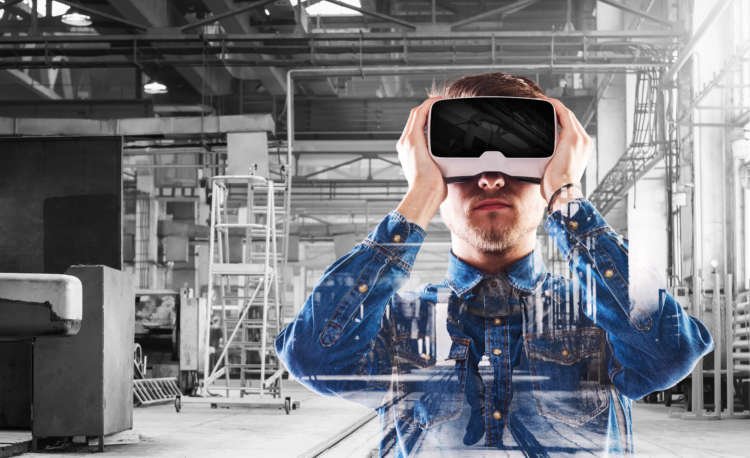 Man in denim shirt wearing virtual reality goggles in a tech environment - Global Banking & Finance Review