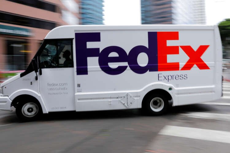 FedEx truck driving through downtown Los Angeles, reflecting labor challenges impacting shares - Global Banking & Finance Review