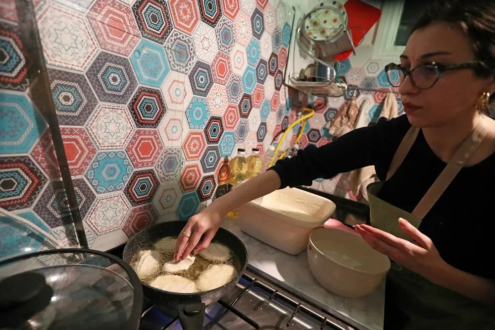 Young couple preparing traditional Georgian food for pro-EU protests in Tbilisi - Global Banking & Finance Review