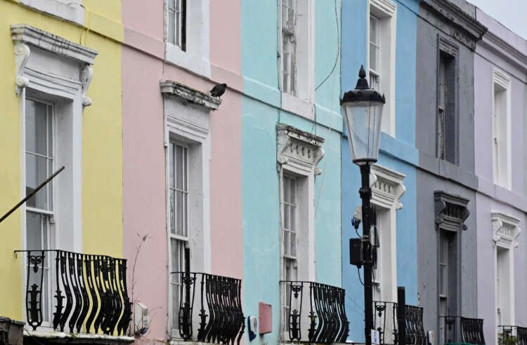 Colorful painted houses in London reflecting the UK housing market trends - Global Banking & Finance Review