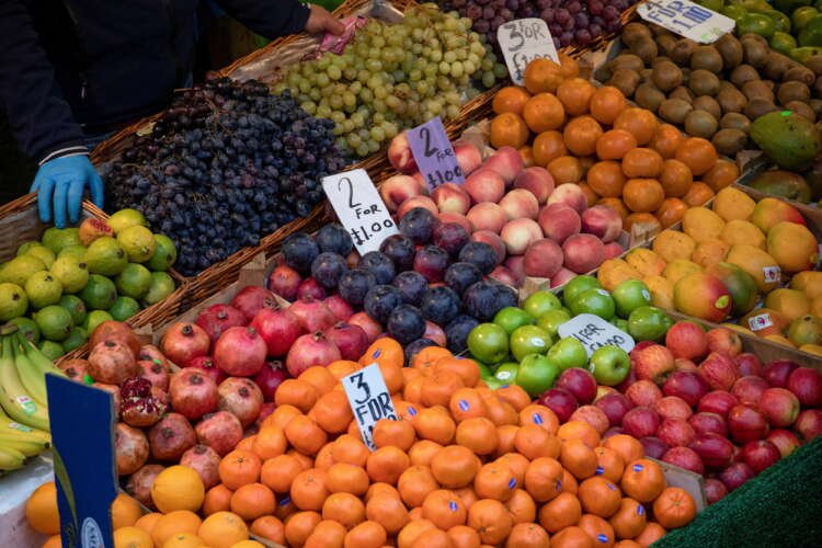 Vibrant display of fresh fruits and vegetables at Brixton Market, highlighting healthy eating habits - Global Banking & Finance Review