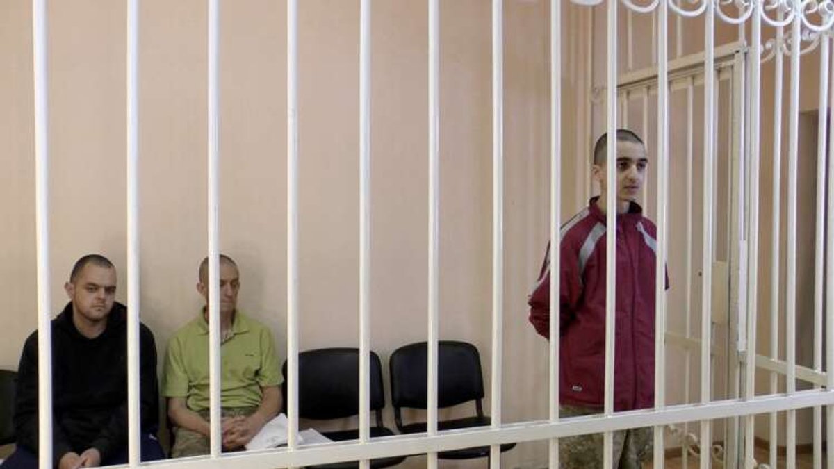 Courtroom scene showing captured Britons and Moroccan facing trial in Donetsk - Global Banking & Finance Review