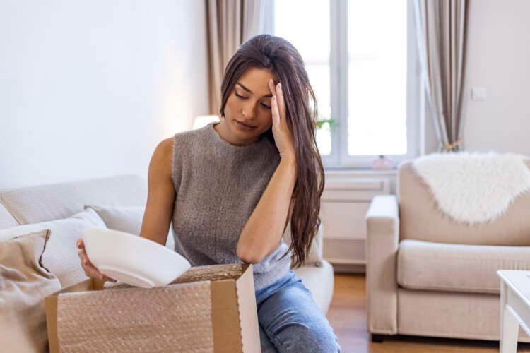 Confused woman examines returned package, reflecting online return challenges - Global Banking & Finance Review