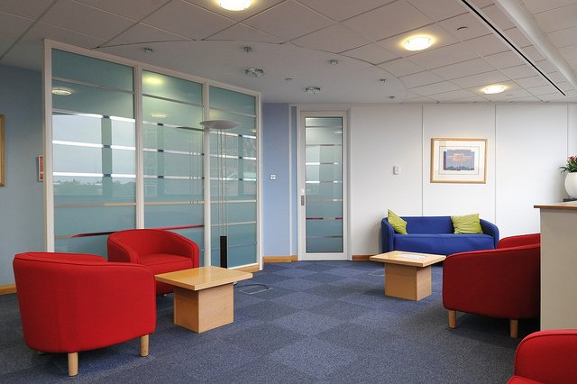 Modern office environment showcasing Eversheds' advanced Wi-Fi setup for video conferencing - Global Banking & Finance Review