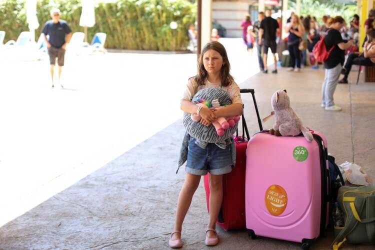 Ukrainian mother and children waiting for relocation bus in Sunny Beach - Global Banking & Finance Review