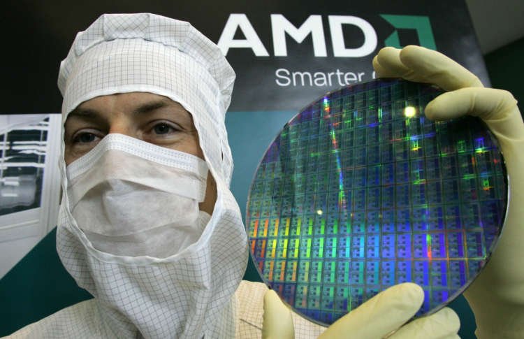 Technician at AMD chip plant in Dresden, showcasing microprocessor wafer - Global Banking & Finance Review