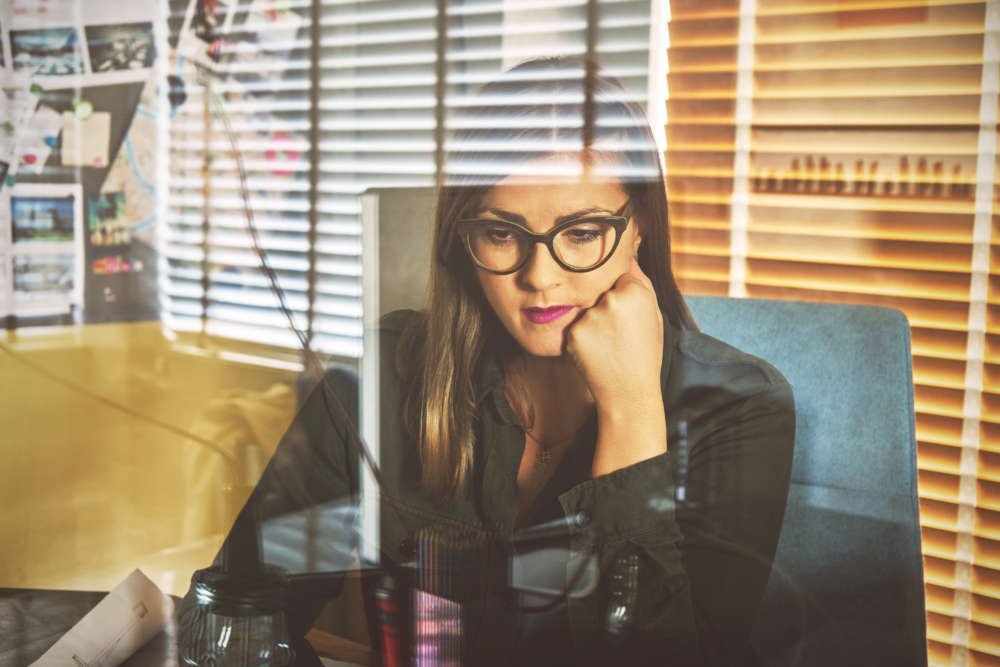 Architect woman working on laptop in a modern workspace, embodying neurodiverse inclusion - Global Banking & Finance Review