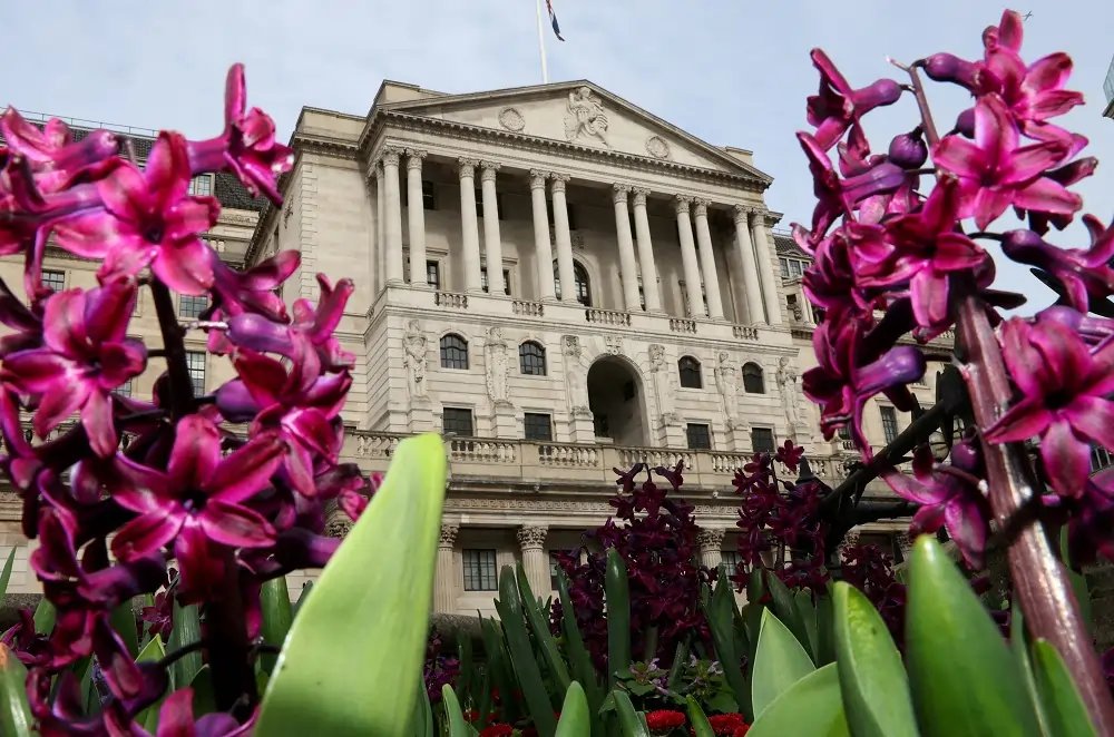 Bank of England building with financial graphs, symbolizing interest rate decisions - Global Banking & Finance Review