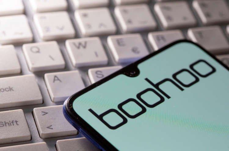 FILE PHOTO: A smartphone with the Boohoo logo displayed is seen on a keyboard in this illustration